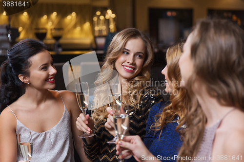 Image of happy women with champagne glasses at night club