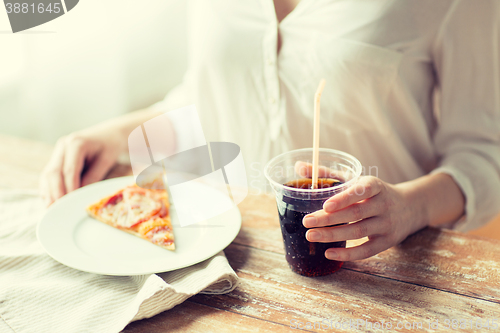 Image of close up of woman with pizza and coca cola drink