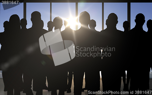 Image of business people silhouettes over office background