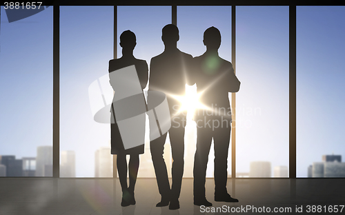 Image of business people silhouettes over office background