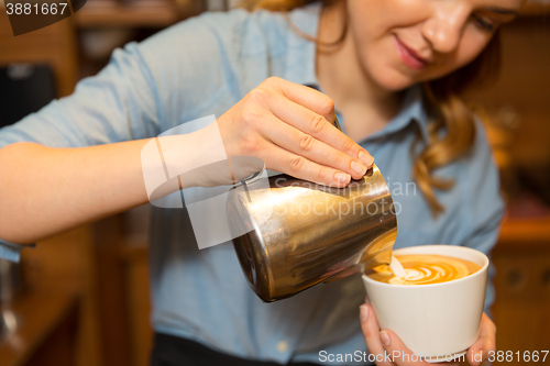 Image of close up of woman making coffee at shop or cafe