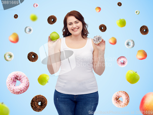 Image of happy plus size woman choosing apple or donut