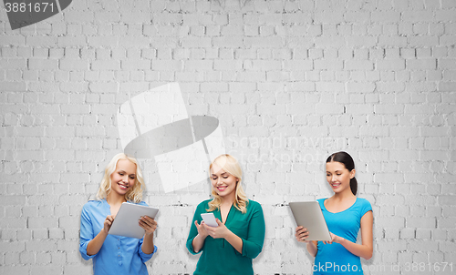 Image of happy women with smartphone and tablet pc computer
