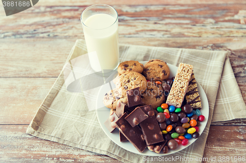 Image of close up of sweet food and milk glass on table