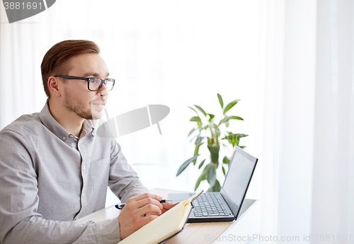 Image of creative male worker or businessman with notebook