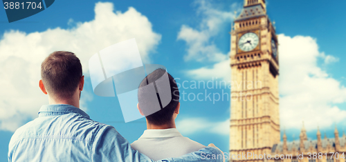 Image of close up of male gay couple hugging over big ben