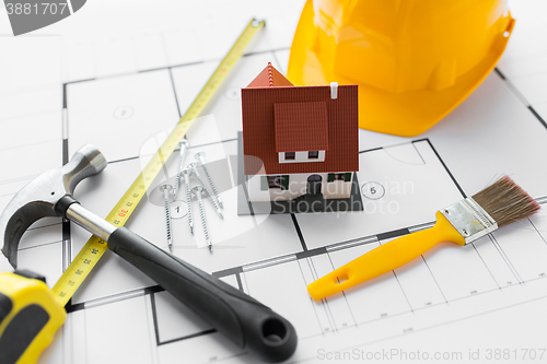 Image of close up of house blueprint with building tools