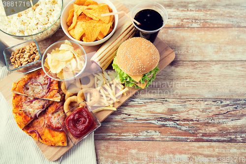 Image of close up of fast food snacks and drink on table