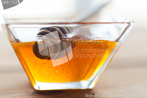 Image of close up of honey in glass bowl and dipper