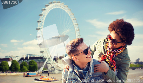 Image of happy teenage couple having fun over london