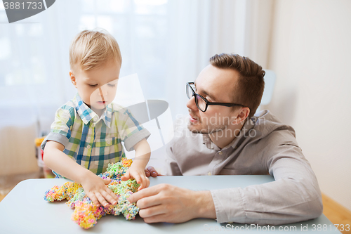 Image of father and son playing with ball clay at home