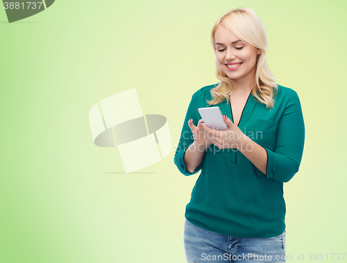 Image of happy woman with smartphone texting message