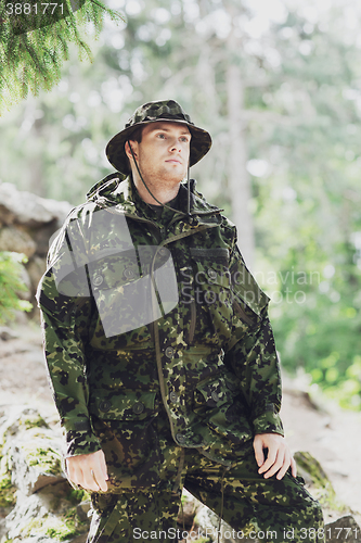 Image of young soldier or ranger in forest