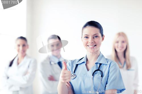 Image of doctor with group of medics showing thumbs up