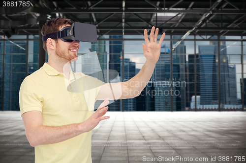 Image of happy man in virtual reality headset or 3d glasses