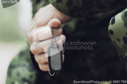 Image of close up of young soldier in military uniform