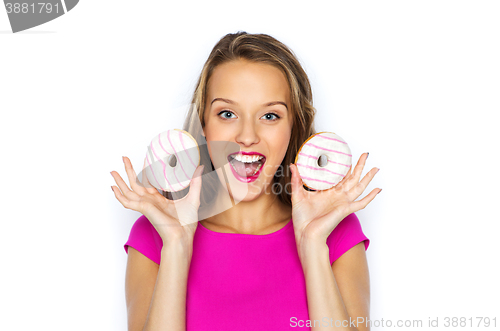 Image of happy woman or teen girl with donuts