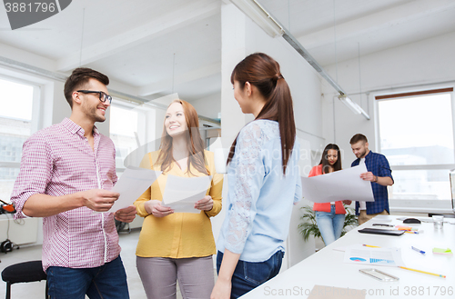 Image of creative team on coffee break talking at office