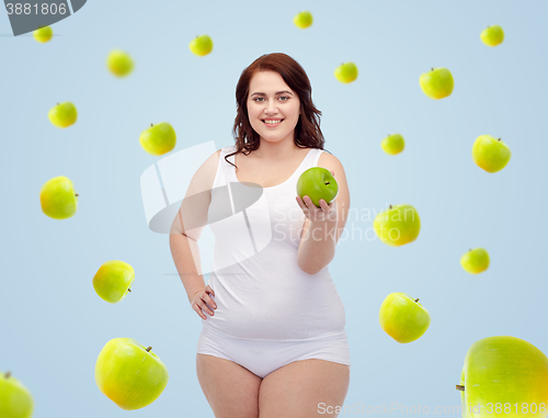 Image of happy plus size woman in underwear with apple