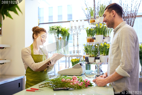 Image of florist woman and man making order at flower shop