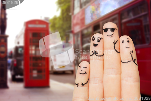 Image of close up of four fingers with smiley faces