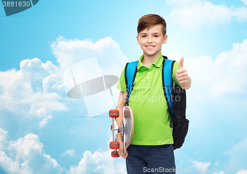 Image of boy with backpack and skateboard showing thumbs up