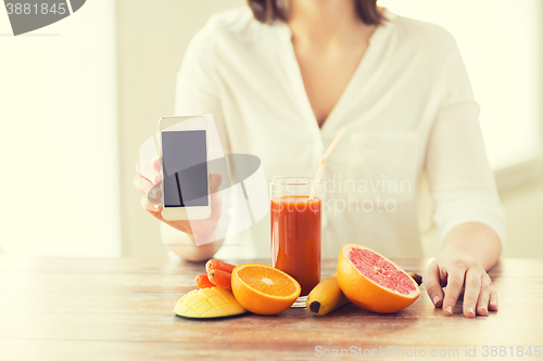 Image of close up of woman hands with smartphone fruits