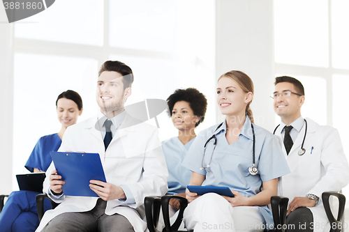 Image of group of happy doctors on seminar at hospital