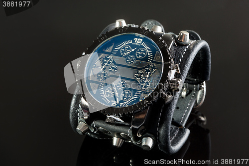 Image of close-up of wristwatch on a black background
