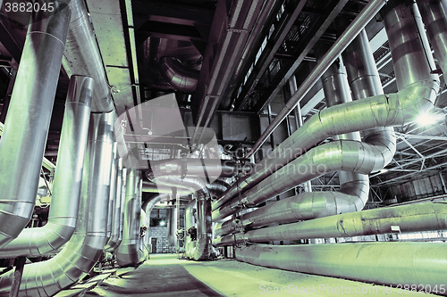 Image of different size and shaped pipes and valves at a power plant 