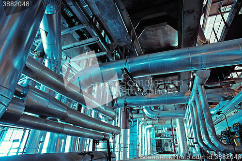 Image of Equipment, cables and piping as found inside of a modern industrial power plant