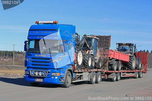 Image of Blue Scania Truck Hauls Agricultural Equipment