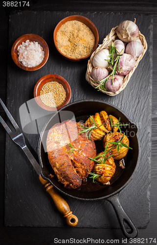 Image of Pulled pork dish with backed rustic potates