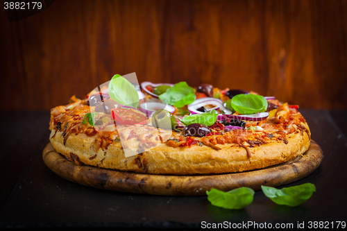 Image of Traditional homemade pizza with tomatoes and olives