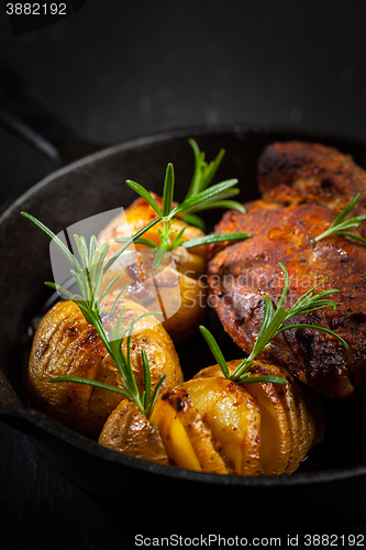 Image of Pulled pork dish with backed rustic potates