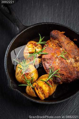 Image of Pulled pork dish with backed rustic potates