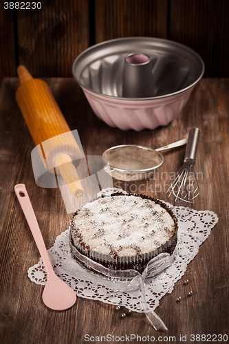 Image of White and chocolate Christmas cake with baking utensils