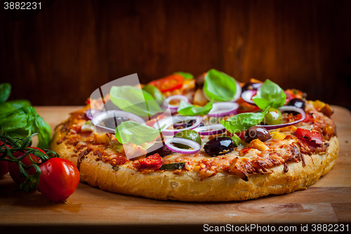 Image of Traditional homemade pizza with tomatoes and olives