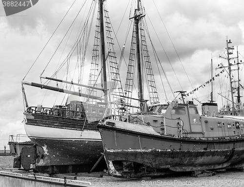 Image of Old collapsing sailboats at the dock, close-up