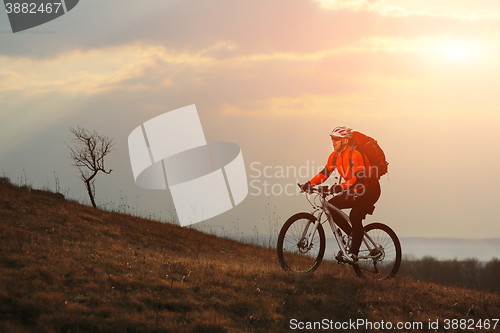 Image of Man cyclist with backpack riding the bicycle