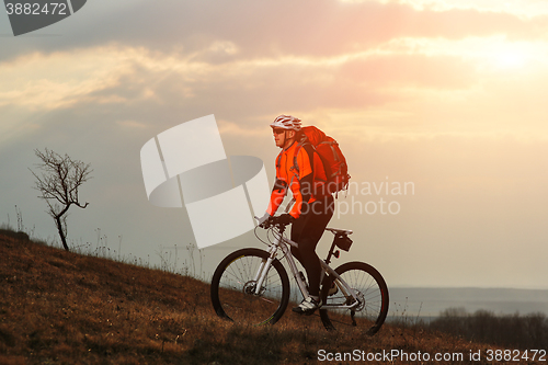 Image of Man cyclist with backpack riding the bicycle