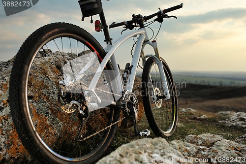 Image of Bicycle stands on a rock