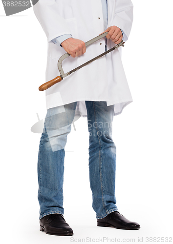 Image of Crazy doctor is holding a big saw in his hands