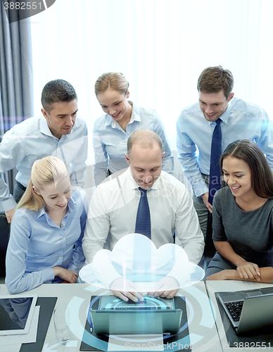 Image of smiling business people with laptop in office