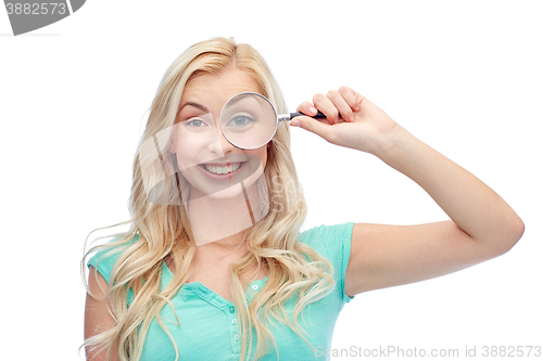 Image of happy young woman with magnifying glass