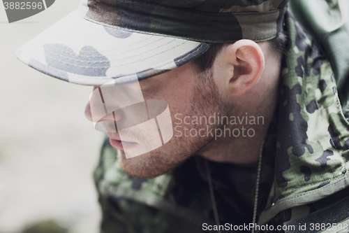 Image of close up of young soldier in military uniform