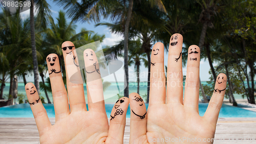 Image of close up of hands and fingers with smiley faces