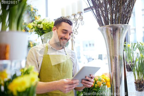 Image of man with tablet pc computer at flower shop