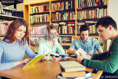 Image of students reading books in library