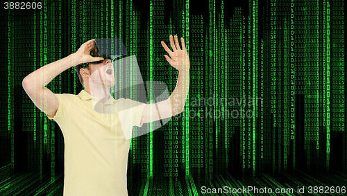 Image of young man in virtual reality headset or 3d glasses